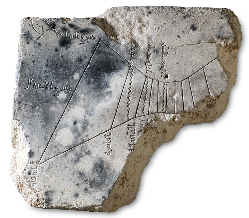 An irregularly shaped stone fragment incised with lines and calligraphy.