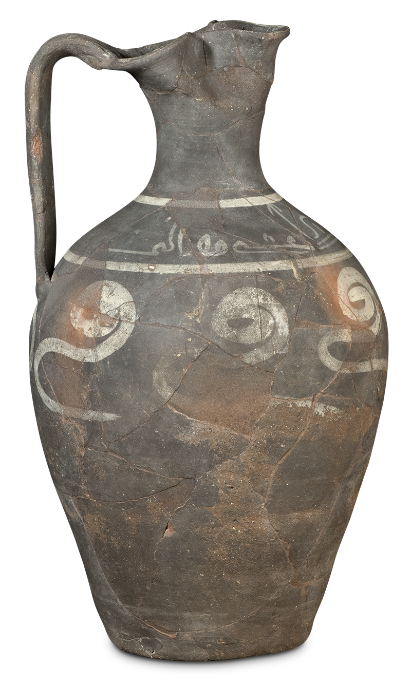 A tall ceramic vessel reconstructed from fragments, with a narrow neck, a spout, and a handle, and is painted with abstract bands and calligraphy.