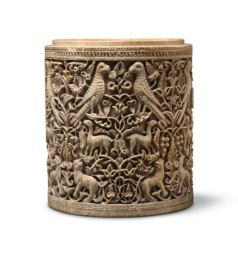 An open cylindrical container decorated with animal and vegetal ornament in relief.